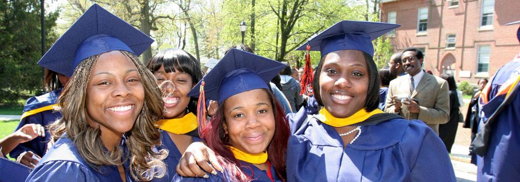 Four graduation women with graduation caps