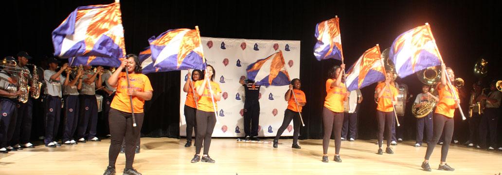 Students performing with flags