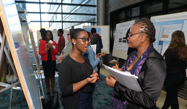 Two ladies standing at a poster presentation
