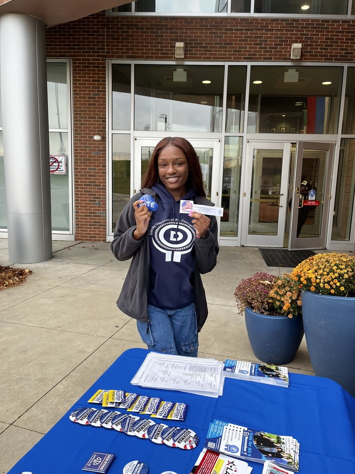 LincolnU student with vote stickers