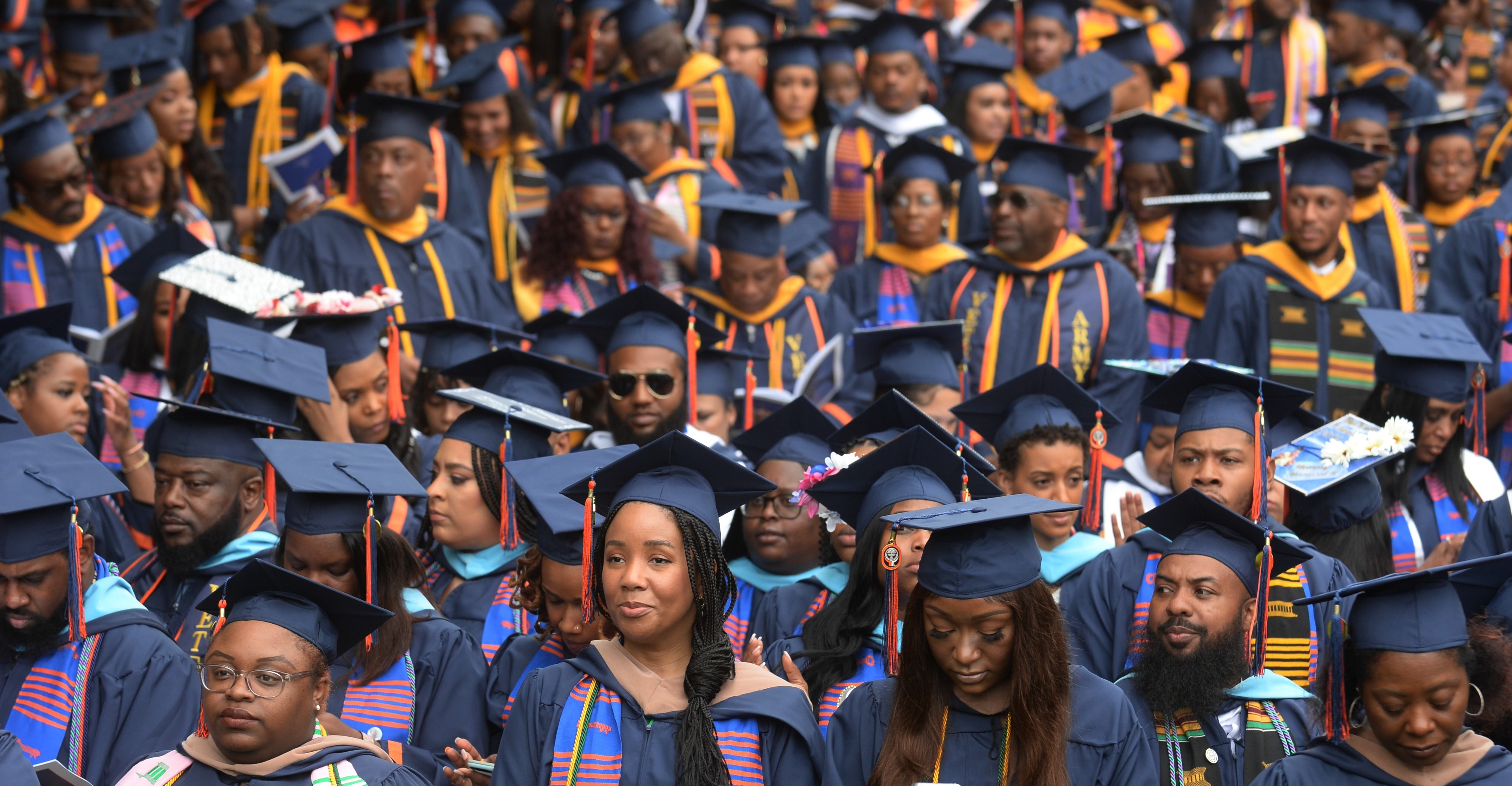 three students graduating