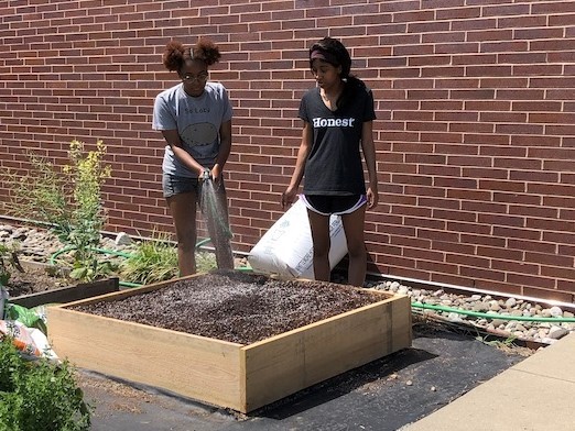 Two students planting